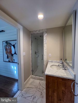 Bathroom, Dual Sink Vanities, Glass Shower, Interior, Marble, Marble Walls, Recessed Lighting