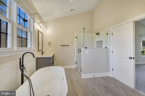 Bathroom, Dual Sink Vanities, Free Standing Baths, Glass Shower, Interior, Recessed Lighting, Wood Texture Flooring