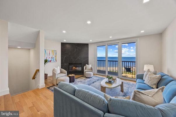 Fireplace, Interior, Living room, Marble Walls, Recessed Lighting, Water, Wood Texture Flooring
