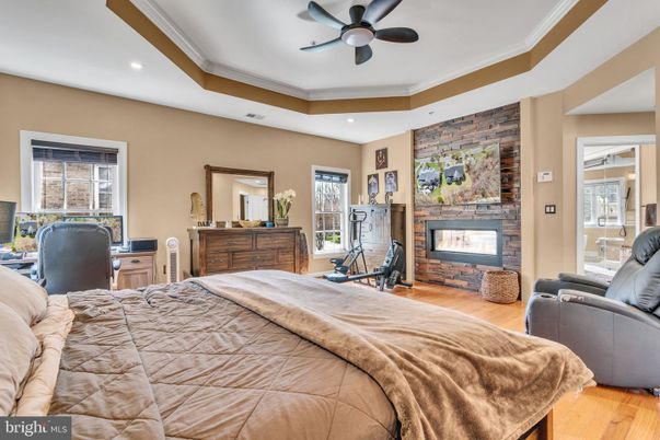 Bedroom, Fireplace, Fitness Equipment, Interior, Recessed Lighting, Stone Walls, Wood Texture Flooring