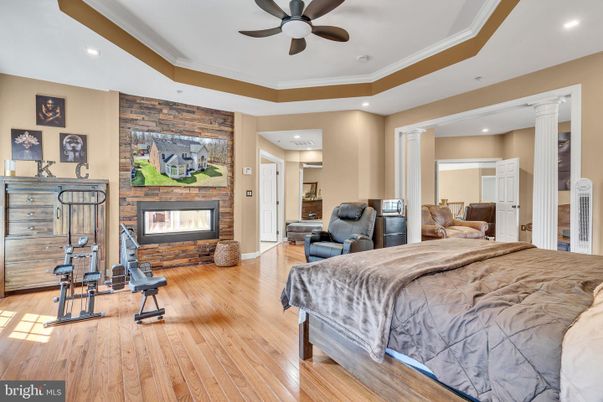 Bedroom, Fireplace, Fitness Equipment, Interior, Recessed Lighting, Stone Walls, Wood Texture Flooring