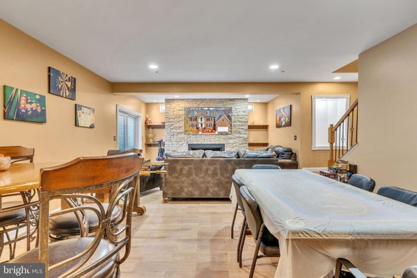 Dining room, Fireplace, Interior, Living room, Recessed Lighting, Stone Walls, Wood Texture Flooring
