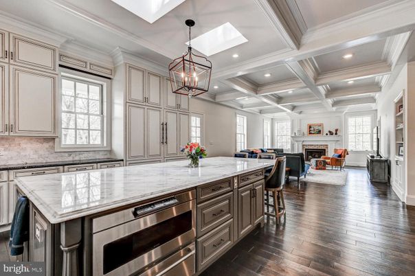 Chandelier, Fireplace, Interior, Kitchen, Living room, Pendant Lights, Recessed Lighting, Stainless Steel Appliances, Wood Texture Flooring