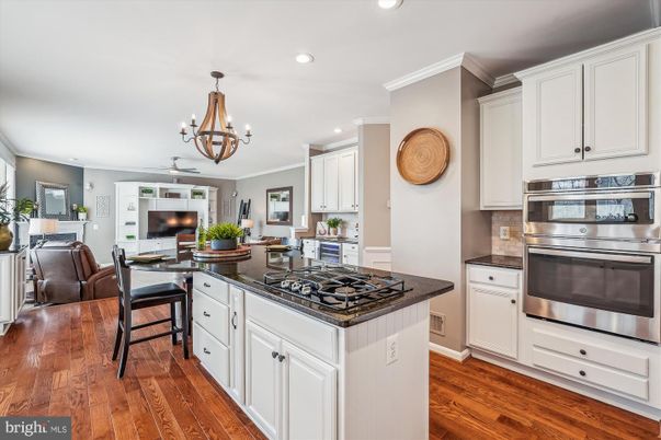 Chandelier, Dining room, Interior, Kitchen, Recessed Lighting, Stainless Steel Appliances, Wood Texture Flooring