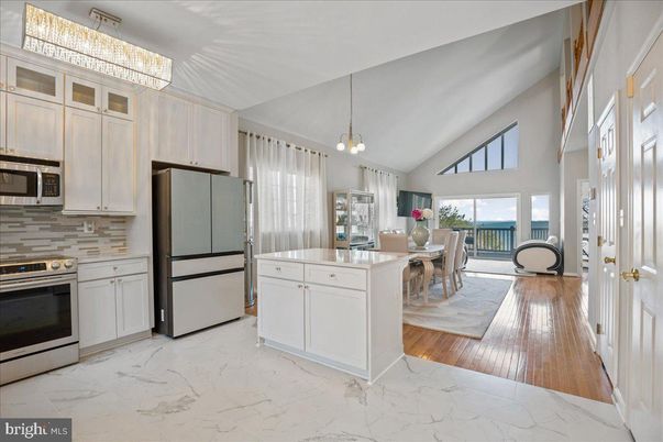 Chandelier, Dining room, Interior, Kitchen, Marble, Pendant Lights, Stainless Steel Appliances, Wood Texture Flooring