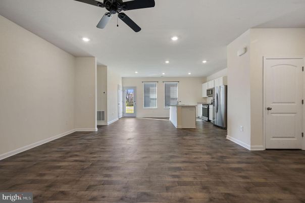 Empty room, Interior, Kitchen, Recessed Lighting, Stainless Steel Appliances, Wood Texture Flooring