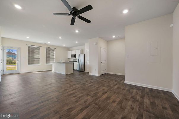 Empty room, Interior, Kitchen, Recessed Lighting, Stainless Steel Appliances, Wood Texture Flooring