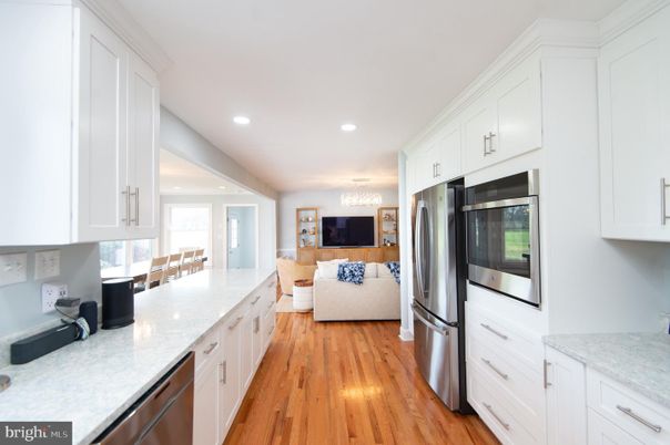 Chandelier, Dining room, Interior, Kitchen, Living room, Recessed Lighting, Stainless Steel Appliances, Wood Texture Flooring