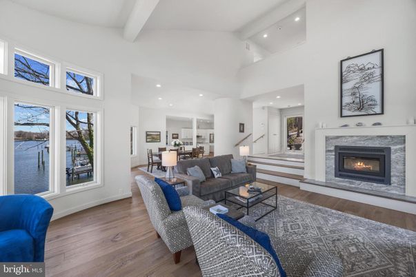 Dining room, Fireplace, Interior, Living room, Recessed Lighting, Water, Wood Texture Flooring