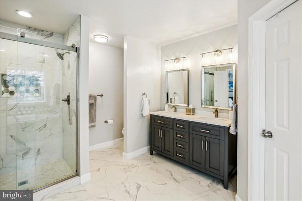 Bathroom, Dual Sink Vanities, Glass Shower, Interior, Marble, Marble Walls, Recessed Lighting