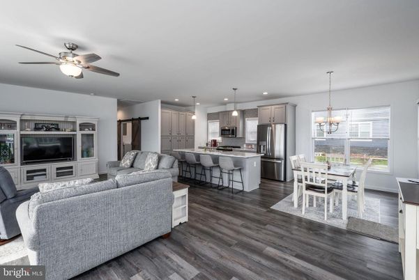Chandelier, Dining room, Interior, Kitchen, Living room, Pendant Lights, Recessed Lighting, Stainless Steel Appliances, Wood Texture Flooring