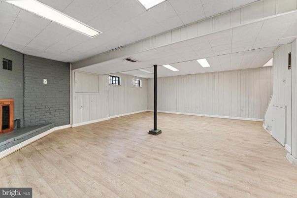 Empty room, Fireplace, Interior, Recessed Lighting, Stone Walls, Wood Texture Flooring