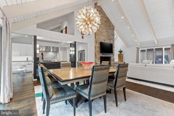 Chandelier, Dining room, Fireplace, Interior, Kitchen, Living room, Pendant Lights, Recessed Lighting, Stainless Steel Appliances, Stone Walls, Wood Texture Flooring