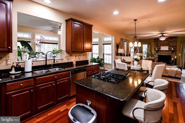 Dining room, Fireplace, Interior, Kitchen, Living room, Pendant Lights, Recessed Lighting, Stainless Steel Appliances, Stone Walls, Wood Texture Flooring