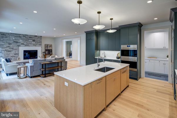 Fireplace, Interior, Kitchen, Living room, Pendant Lights, Recessed Lighting, Stainless Steel Appliances, Stone Walls, Wood Texture Flooring