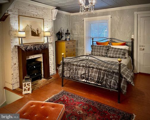 Bedroom, Chandelier, Fireplace, Interior, Stone Walls, Wood Texture Flooring