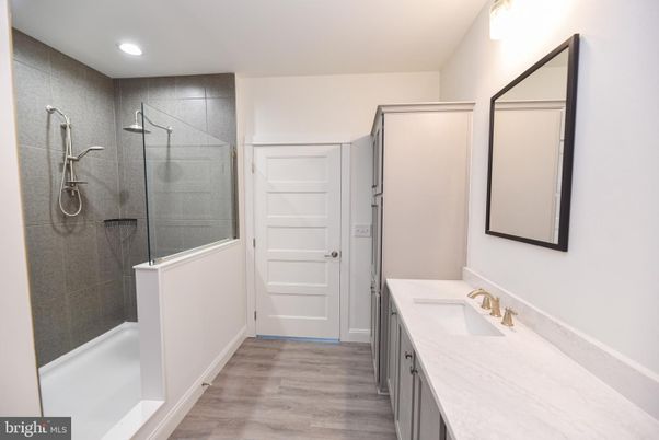 Bathroom, Dual Sink Vanities, Glass Shower, Interior, Recessed Lighting, Wood Texture Flooring