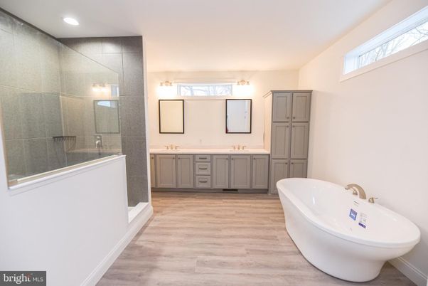 Bathroom, Dual Sink Vanities, Glass Shower, Interior, Recessed Lighting, Wood Texture Flooring