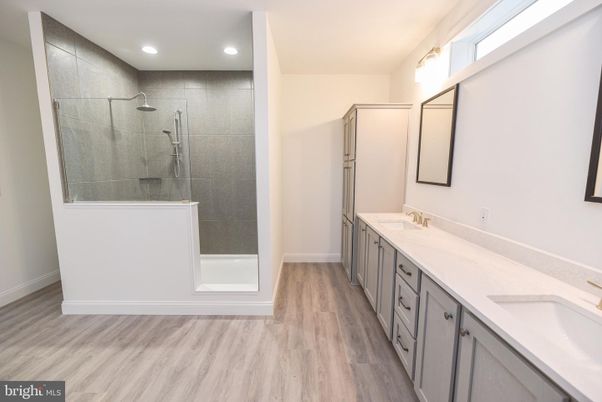 Bathroom, Dual Sink Vanities, Glass Shower, Interior, Recessed Lighting, Wood Texture Flooring