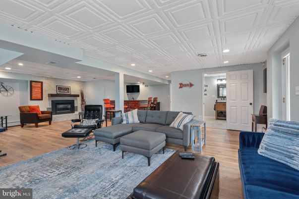 Dining room, Fireplace, Interior, Living room, Recessed Lighting, Stone Walls, Wood Texture Flooring