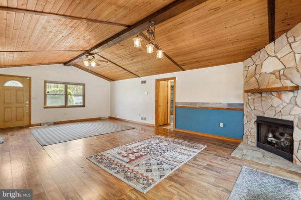 Empty room, Fireplace, Interior, Pendant Lights, Stone Walls, Wooden Beams, Wooden Ceilings, Wood Texture Flooring