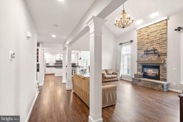 Chandelier, Fireplace, Interior, Kitchen, Living room, Pendant Lights, Recessed Lighting, Stone Walls, Wood Texture Flooring
