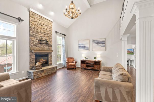 Chandelier, Fireplace, Interior, Recessed Lighting, Stone Walls, Wood Texture Flooring