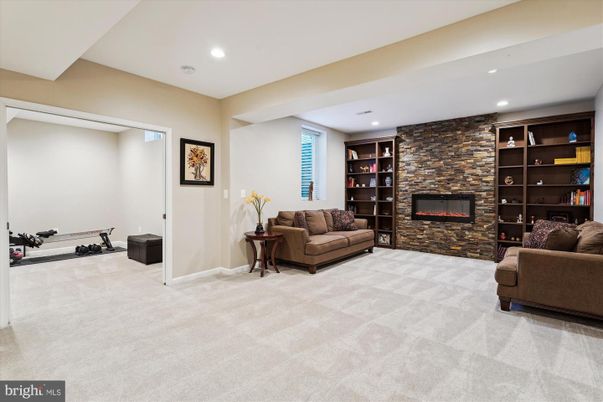 Fireplace, Fitness Equipment, Interior, Living room, Recessed Lighting, Stone Walls
