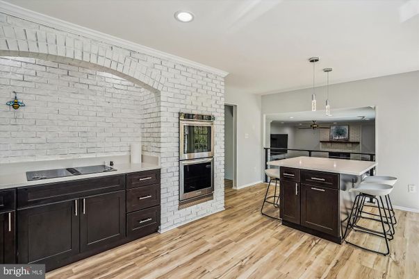 Fireplace, Interior, Kitchen, Pendant Lights, Recessed Lighting, Stainless Steel Appliances, Stone Walls, Wood Texture Flooring