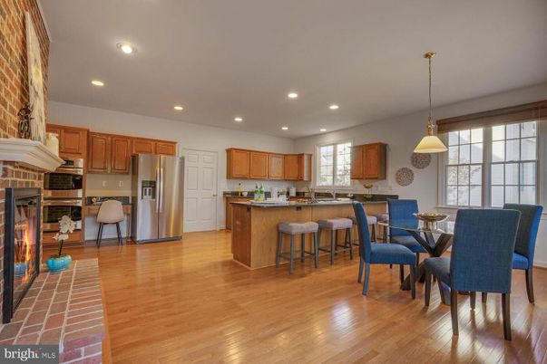 Dining room, Fireplace, Interior, Kitchen, Pendant Lights, Recessed Lighting, Stainless Steel Appliances, Stone Walls, Wood Texture Flooring