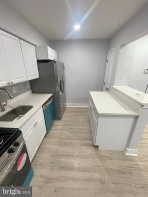 Interior, Kitchen, Recessed Lighting, Washer, Wood Texture Flooring
