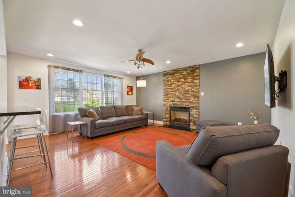 Fireplace, Interior, Living room, Recessed Lighting, Stone Walls, Wood Texture Flooring