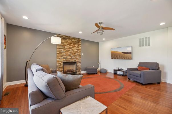 Fireplace, Interior, Living room, Recessed Lighting, Stone Walls, Wood Texture Flooring