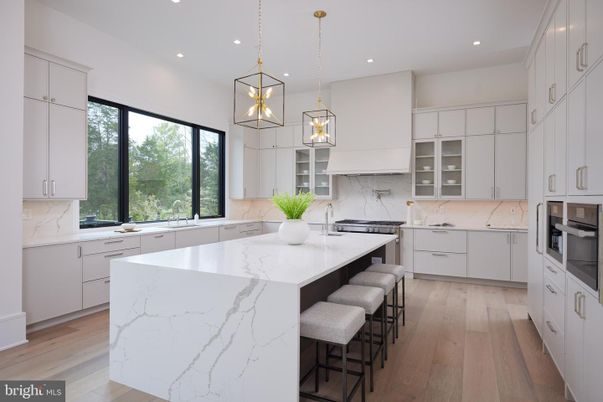Interior, Kitchen, Marble Walls, Pendant Lights, Recessed Lighting, Stainless Steel Appliances, Wood Texture Flooring