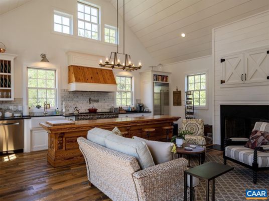 Chandelier, Fireplace, Interior, Kitchen, Living room, Pendant Lights, Recessed Lighting, Stainless Steel Appliances, Wood Texture Flooring