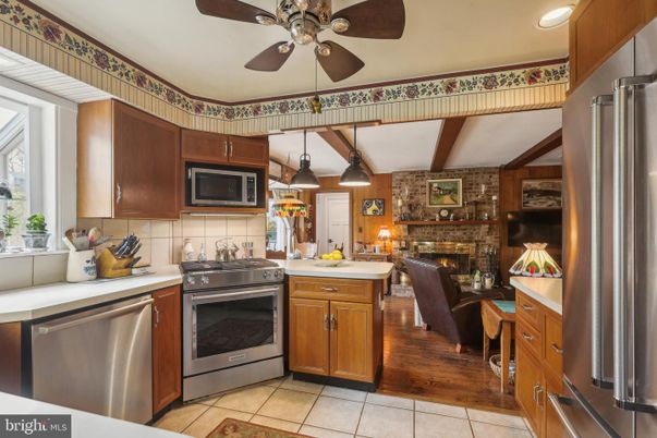 Fireplace, Interior, Kitchen, Living room, Pendant Lights, Recessed Lighting, Stainless Steel Appliances, Stone Walls, Wood Texture Flooring