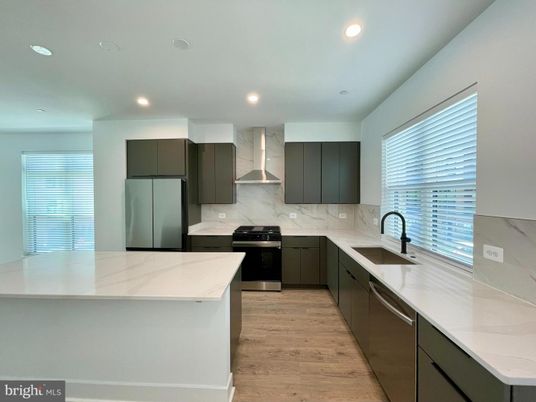 Interior, Kitchen, Marble Walls, Recessed Lighting, Stainless Steel Appliances, Wood Texture Flooring