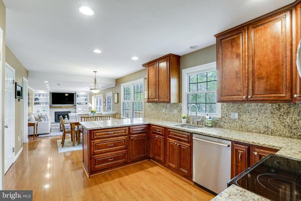 Chandelier, Dining room, Fireplace, Interior, Kitchen, Living room, Recessed Lighting, Stainless Steel Appliances, Wood Texture Flooring