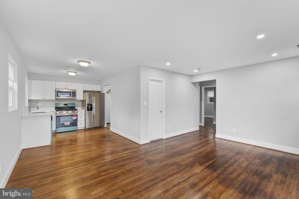 Empty room, Interior, Kitchen, Recessed Lighting, Stainless Steel Appliances, Wood Texture Flooring
