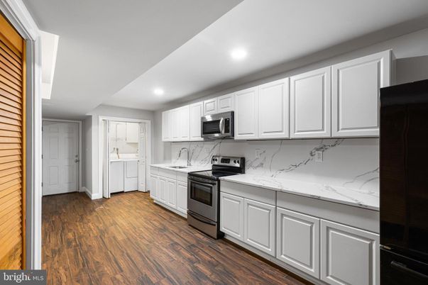 Interior, Kitchen, Marble Walls, Recessed Lighting, Stainless Steel Appliances, Wood Texture Flooring