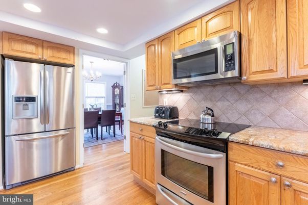 Chandelier, Dining room, Interior, Kitchen, Recessed Lighting, Stainless Steel Appliances, Wood Texture Flooring