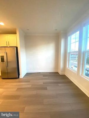 Empty room, Interior, Kitchen, Recessed Lighting, Stainless Steel Appliances, Wood Texture Flooring