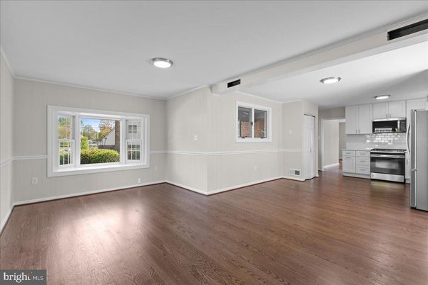 Empty room, Interior, Kitchen, Recessed Lighting, Stainless Steel Appliances, Wood Texture Flooring