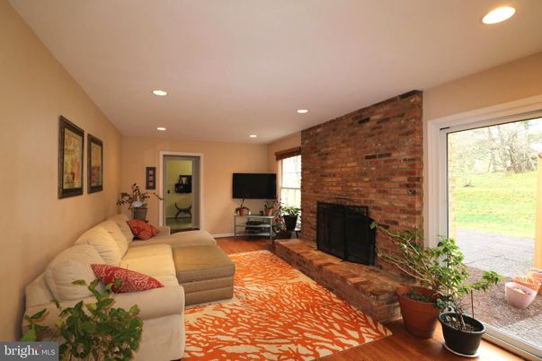 Fireplace, Interior, Living room, Recessed Lighting, Stone Walls, Wood Texture Flooring