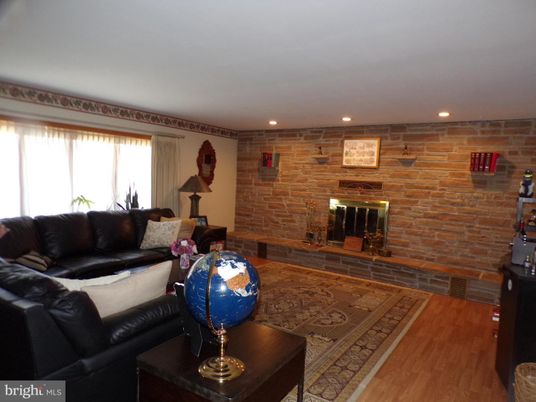 Fireplace, Interior, Living room, Recessed Lighting, Stone Walls, Wood Texture Flooring