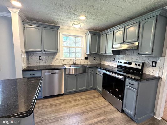 Interior, Kitchen, Marble Walls, Recessed Lighting, Stainless Steel Appliances, Wood Texture Flooring