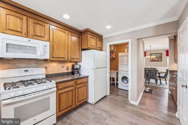 Chandelier, Dining room, Interior, Kitchen, Recessed Lighting, Washer, Wood Texture Flooring
