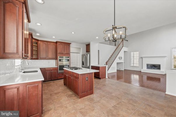 Chandelier, Fireplace, Interior, Kitchen, Pendant Lights, Recessed Lighting, Stainless Steel Appliances, Wood Texture Flooring