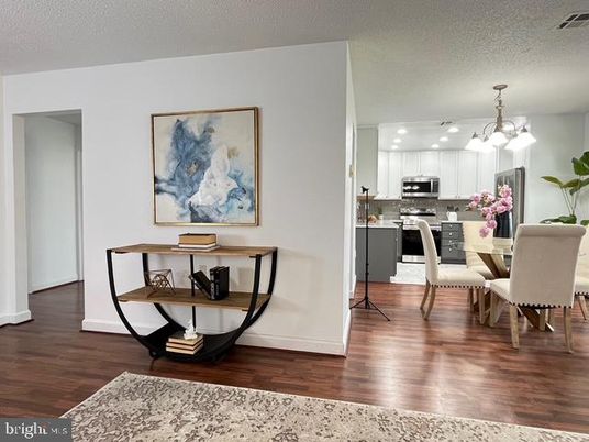 Chandelier, Dining room, Interior, Kitchen, Pendant Lights, Recessed Lighting, Stainless Steel Appliances, Wood Texture Flooring