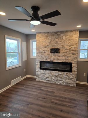 Empty room, Fireplace, Interior, Recessed Lighting, Stone Walls, Wood Texture Flooring